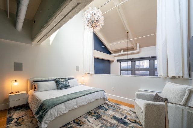 bedroom with hardwood / wood-style floors and a notable chandelier