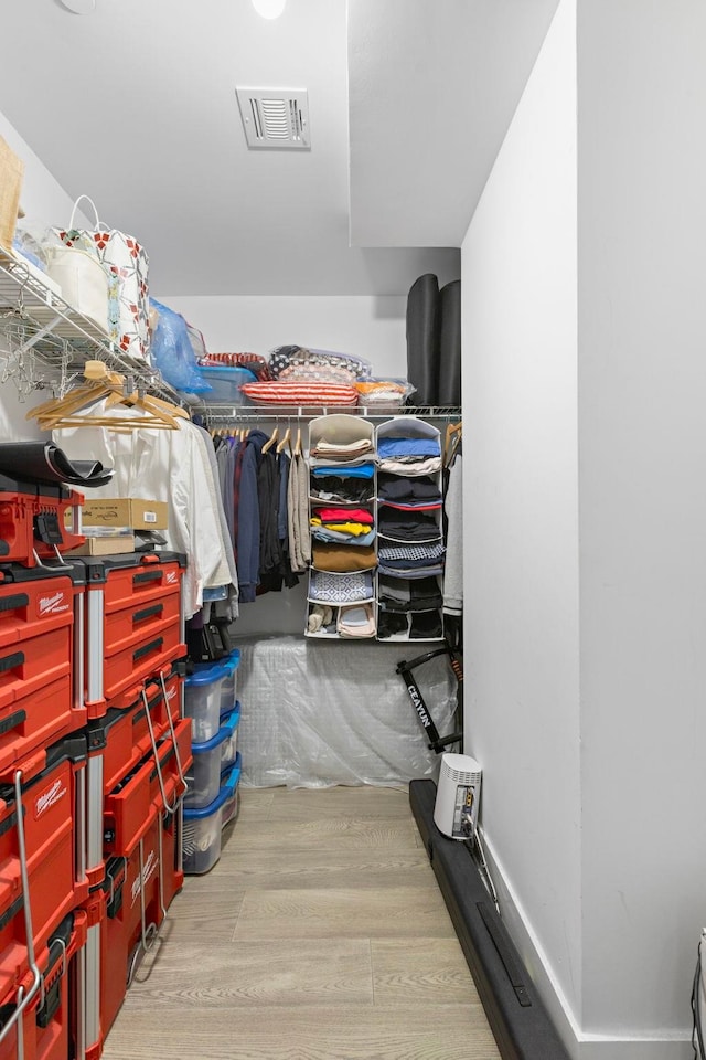 walk in closet featuring visible vents and wood finished floors