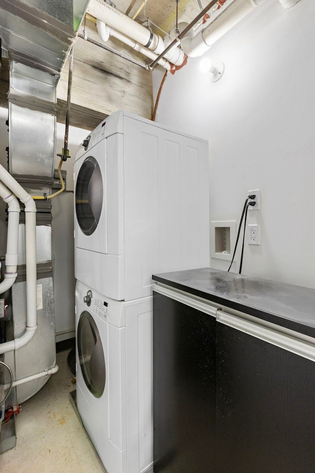 laundry area featuring laundry area and stacked washer / drying machine