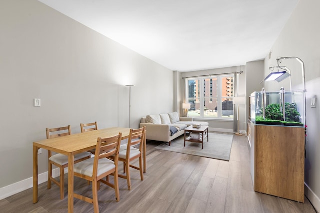 dining area with wood finished floors and baseboards