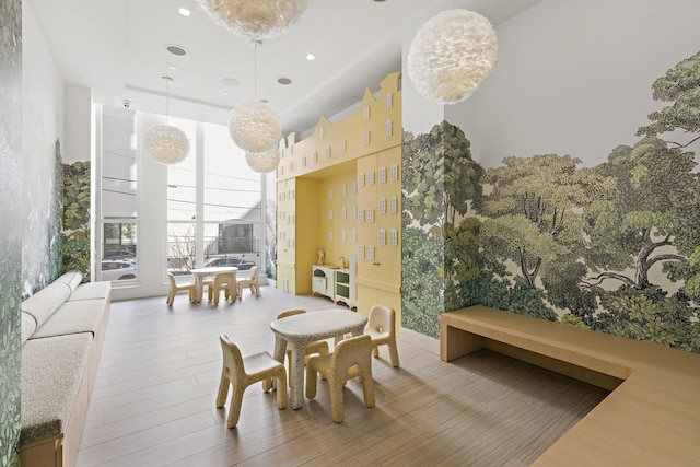 dining area with wood finished floors, expansive windows, and recessed lighting