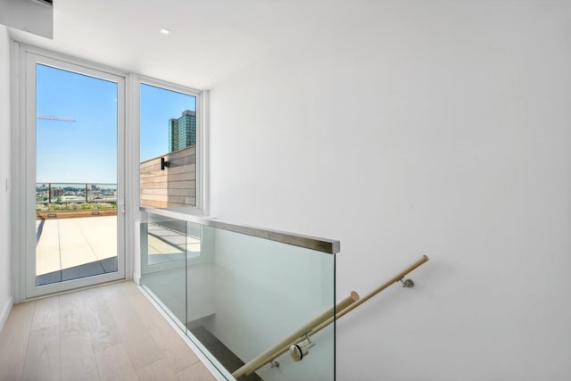 doorway to outside with wood finished floors and baseboards