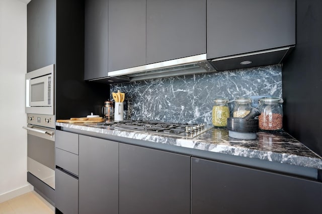kitchen featuring appliances with stainless steel finishes, modern cabinets, decorative backsplash, and gray cabinetry