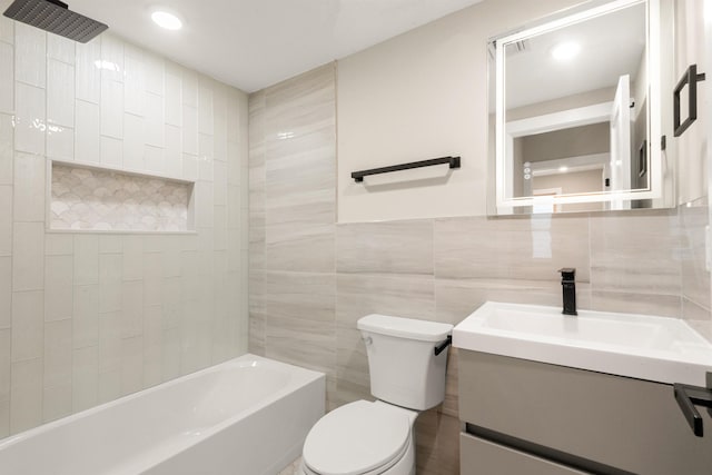211 Summit Ave Unit 2, Jersey City, NJ 07304 - bathroom featuring vanity, tile walls, washtub / shower combination, and recessed lighting