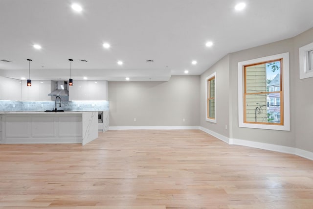 211 Summit Ave Unit 2, Jersey City, NJ 07304 - kitchen with white cabinetry, recessed lighting, decorative backsplash, light wood-style flooring, and open floor plan