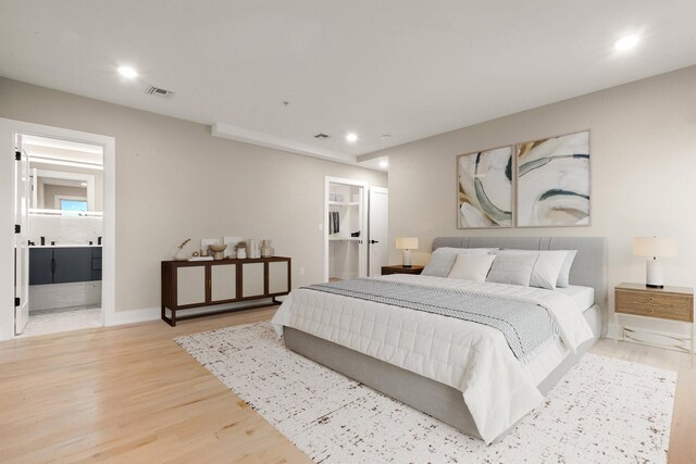 211 Summit Ave Unit 2, Jersey City, NJ 07304 - bedroom with light wood finished floors, recessed lighting, a walk in closet, connected bathroom, and a closet