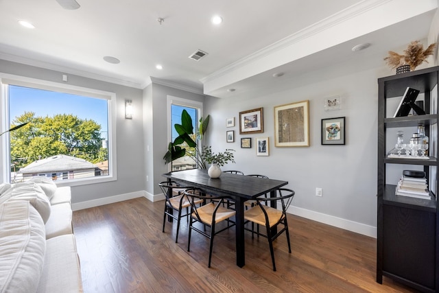 dining area featuring dark hardwood / wood-style flooring and ornamental molding