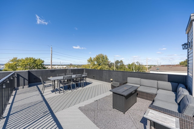 wooden deck with an outdoor living space with a fire pit