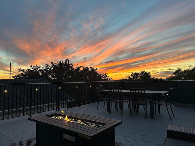 deck at dusk with an outdoor fire pit