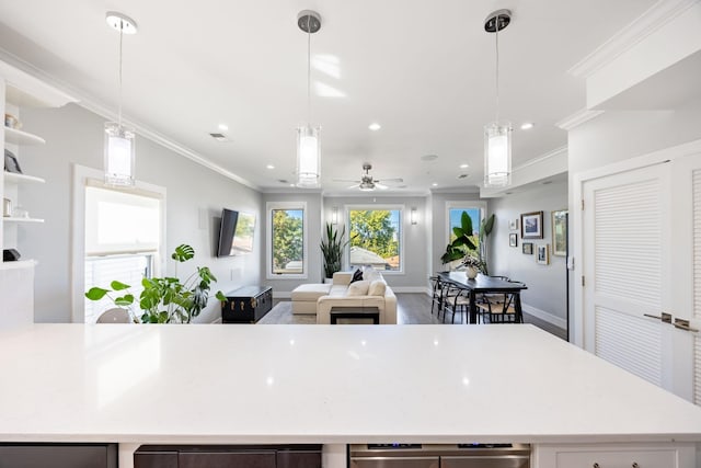 kitchen featuring ceiling fan, pendant lighting, and ornamental molding