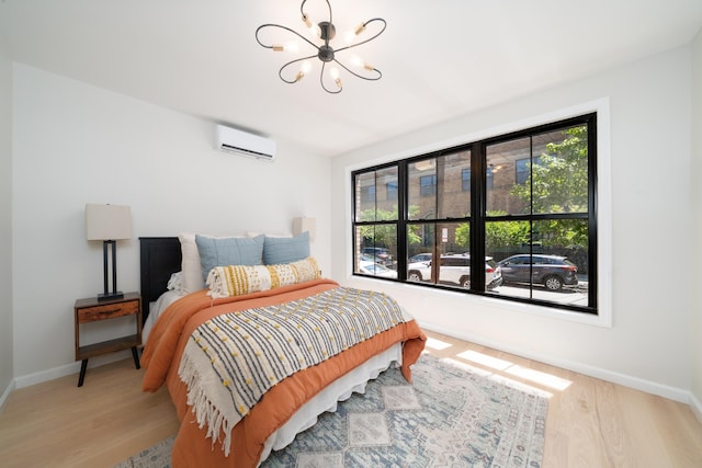 366 7th St Unit 1, Jersey City, NJ 07302 - bedroom featuring a wall mounted AC, a chandelier, and wood finished floors