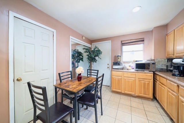 kitchen featuring stainless steel microwave, recessed lighting, backsplash, light brown cabinets, and light tile patterned floors