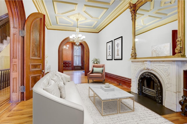 living room with crown molding, a fireplace, and coffered ceiling