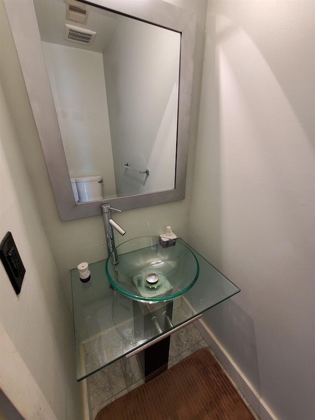 bathroom with visible vents and a sink