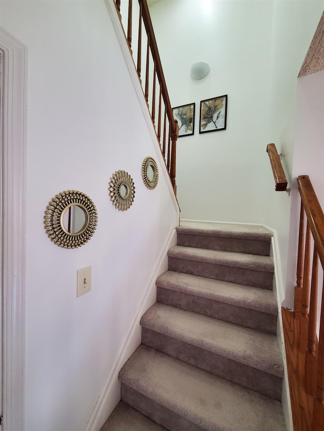 stairway featuring baseboards