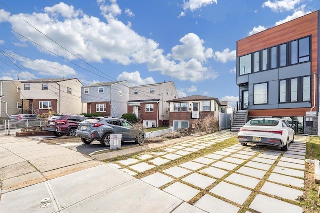 33 Suburbia Ct Unit A, Jersey City, NJ 07305 - view of vehicle parking with a residential view, concrete driveway, and stairway