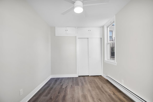 unfurnished bedroom with a baseboard radiator, a closet, light hardwood / wood-style floors, and ceiling fan