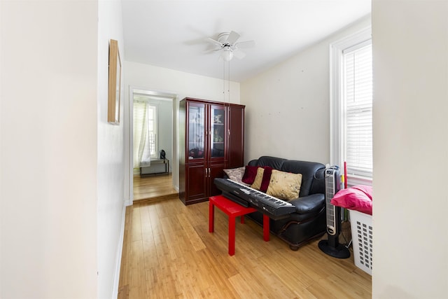 sitting room featuring light wood-type flooring and ceiling fan