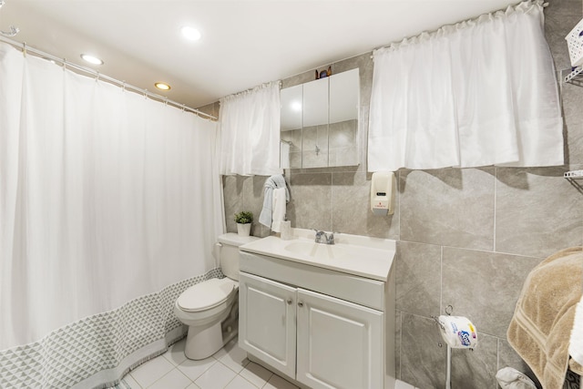 full bathroom with tile patterned floors, vanity, toilet, tile walls, and a shower with curtain