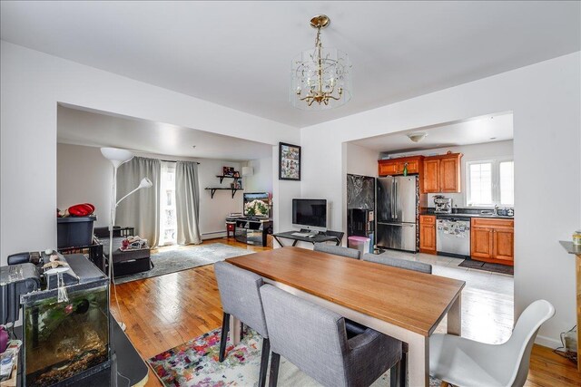 55 71st St, Guttenberg, NJ 07093 - dining area with a chandelier and light wood-style flooring