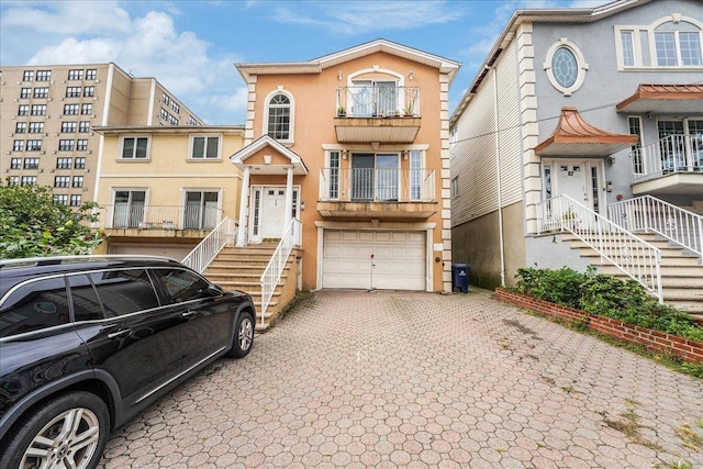 55 71st St, Guttenberg, NJ 07093 - multi unit property featuring decorative driveway, stucco siding, an attached garage, and stairway