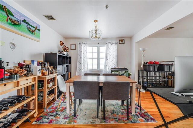 55 71st St, Guttenberg, NJ 07093 - dining space with wood finished floors and a chandelier