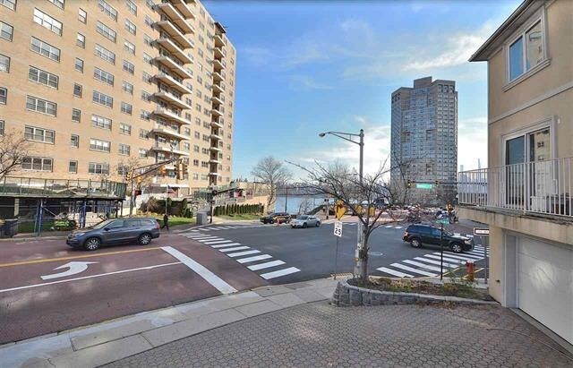 55 71st St, Guttenberg, NJ 07093 - view of asphalt road featuring street lights and curbs