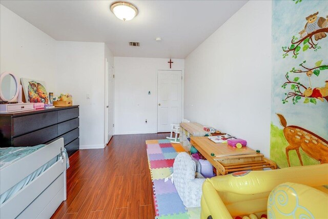 55 71st St, Guttenberg, NJ 07093 - bedroom with wood finished floors and baseboards