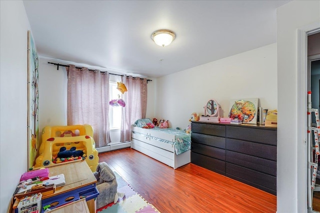 55 71st St, Guttenberg, NJ 07093 - bedroom with baseboard heating and wood finished floors