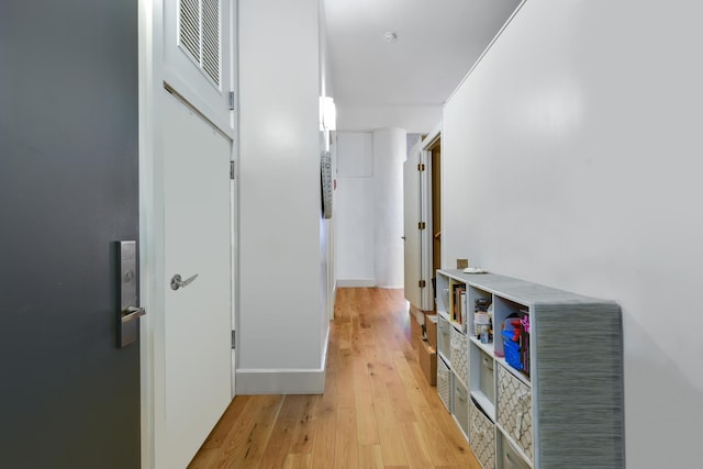 corridor with light wood-type flooring