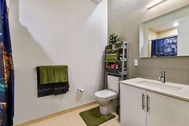 bathroom featuring tasteful backsplash, tile patterned floors, toilet, and vanity