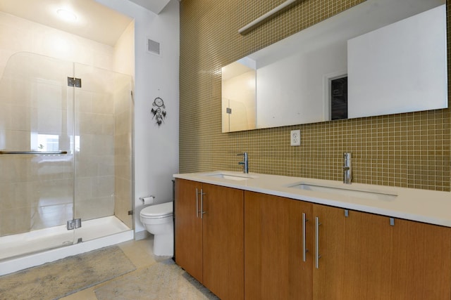 bathroom with tasteful backsplash, tile walls, vanity, an enclosed shower, and toilet