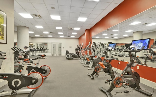 exercise room featuring a drop ceiling