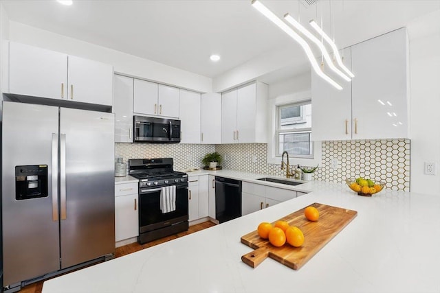54 Logan Ave Unit 1, Jersey City, NJ 07306 - kitchen with appliances with stainless steel finishes, a sink, light countertops, white cabinetry, and recessed lighting