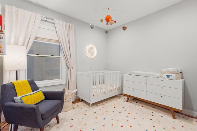 1163 Summit Ave Unit 1, Jersey City, NJ 07307 - bedroom featuring a nursery area and baseboards