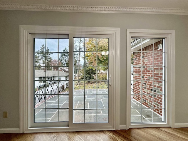 entryway with light hardwood / wood-style flooring and ornamental molding