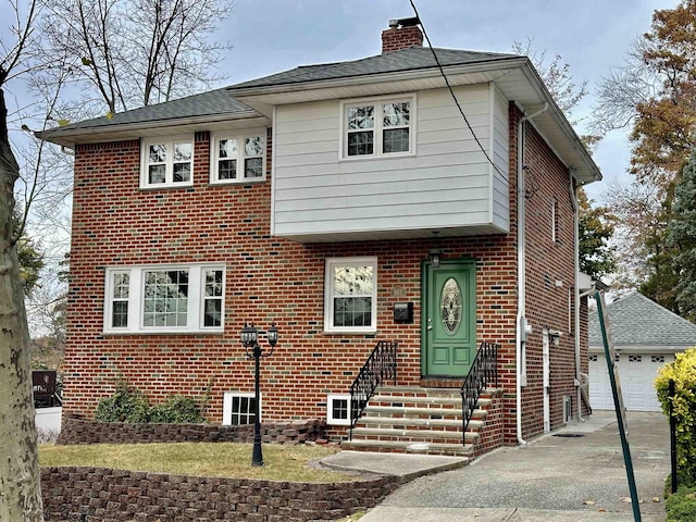 view of front of home with a garage and an outdoor structure