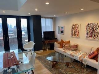 living area with light wood-style floors and recessed lighting