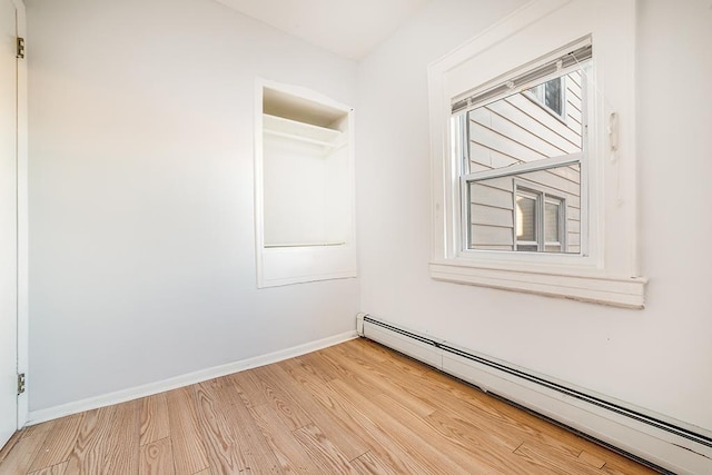 1043 Broadway, Bayonne, NJ 07002 - unfurnished room featuring baseboard heating, light wood finished floors, and baseboards