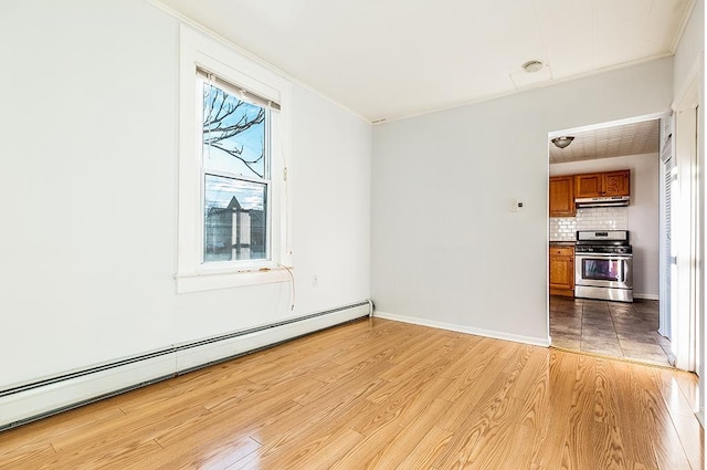 1043 Broadway, Bayonne, NJ 07002 - empty room with a baseboard radiator, light wood-type flooring, ornamental molding, and baseboards