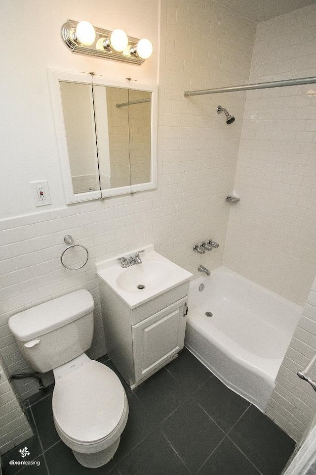 1043 Broadway, Bayonne, NJ 07002 - full bath with toilet, tile walls, tile patterned flooring, vanity, and shower / washtub combination