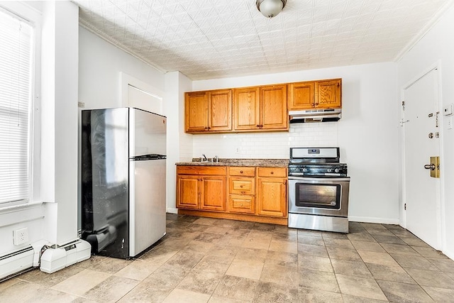 1043 Broadway, Bayonne, NJ 07002 - kitchen featuring freestanding refrigerator, stainless steel gas range, under cabinet range hood, brown cabinetry, and decorative backsplash