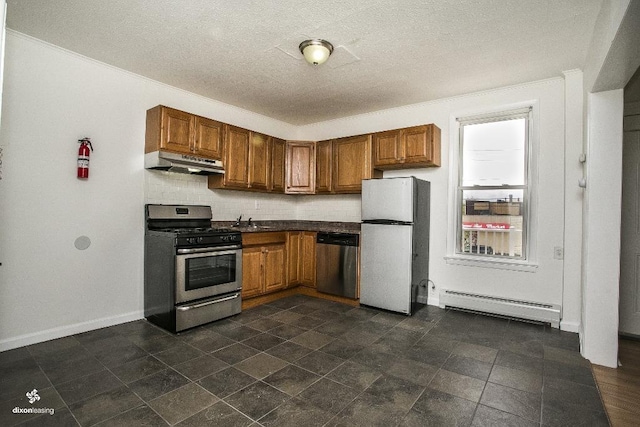 1043 Broadway, Bayonne, NJ 07002 - kitchen with appliances with stainless steel finishes, baseboard heating, under cabinet range hood, brown cabinetry, and a textured ceiling