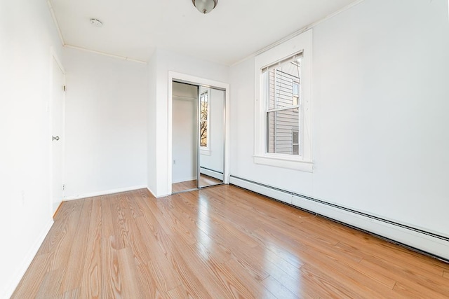 1043 Broadway, Bayonne, NJ 07002 - spare room with a baseboard radiator, wood finished floors, ornamental molding, baseboards, and a smoke detector