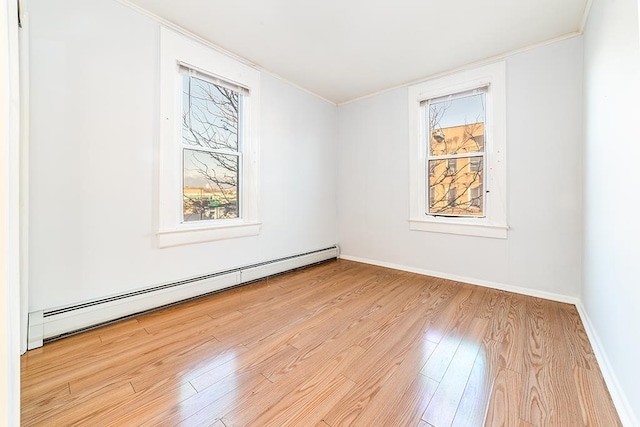 1043 Broadway, Bayonne, NJ 07002 - spare room featuring a baseboard radiator, wood finished floors, ornamental molding, healthy amount of natural light, and baseboards