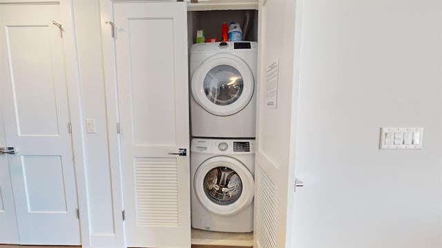 washroom featuring stacked washer and dryer