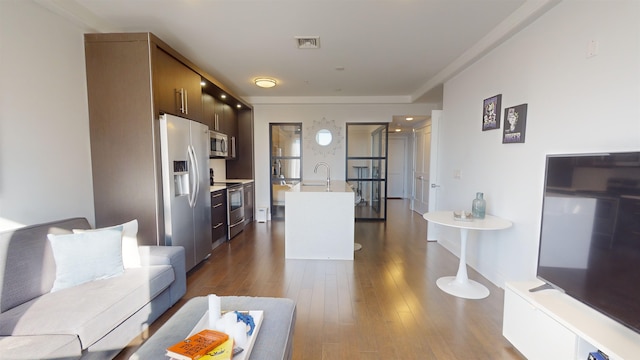 living room featuring hardwood / wood-style flooring and sink