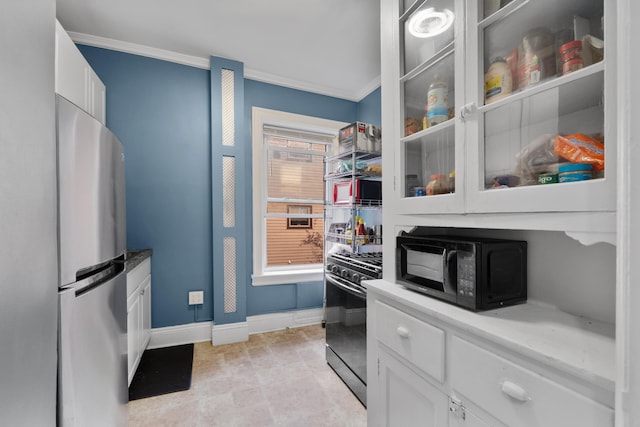 122 W 39th St Unit A4, Bayonne, NJ 07302 - kitchen featuring stainless steel appliances, ornamental molding, white cabinets, and glass insert cabinets