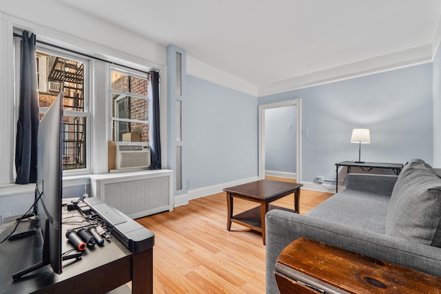 122 W 39th St Unit A4, Bayonne, NJ 07302 - living area with radiator, cooling unit, and light wood finished floors