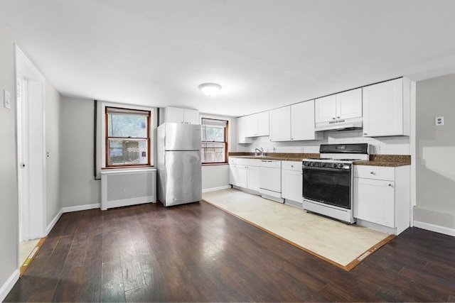37 Pearsall Ave, Jersey City, NJ 07305 - kitchen with white appliances, under cabinet range hood, radiator heating unit, dark countertops, and baseboards